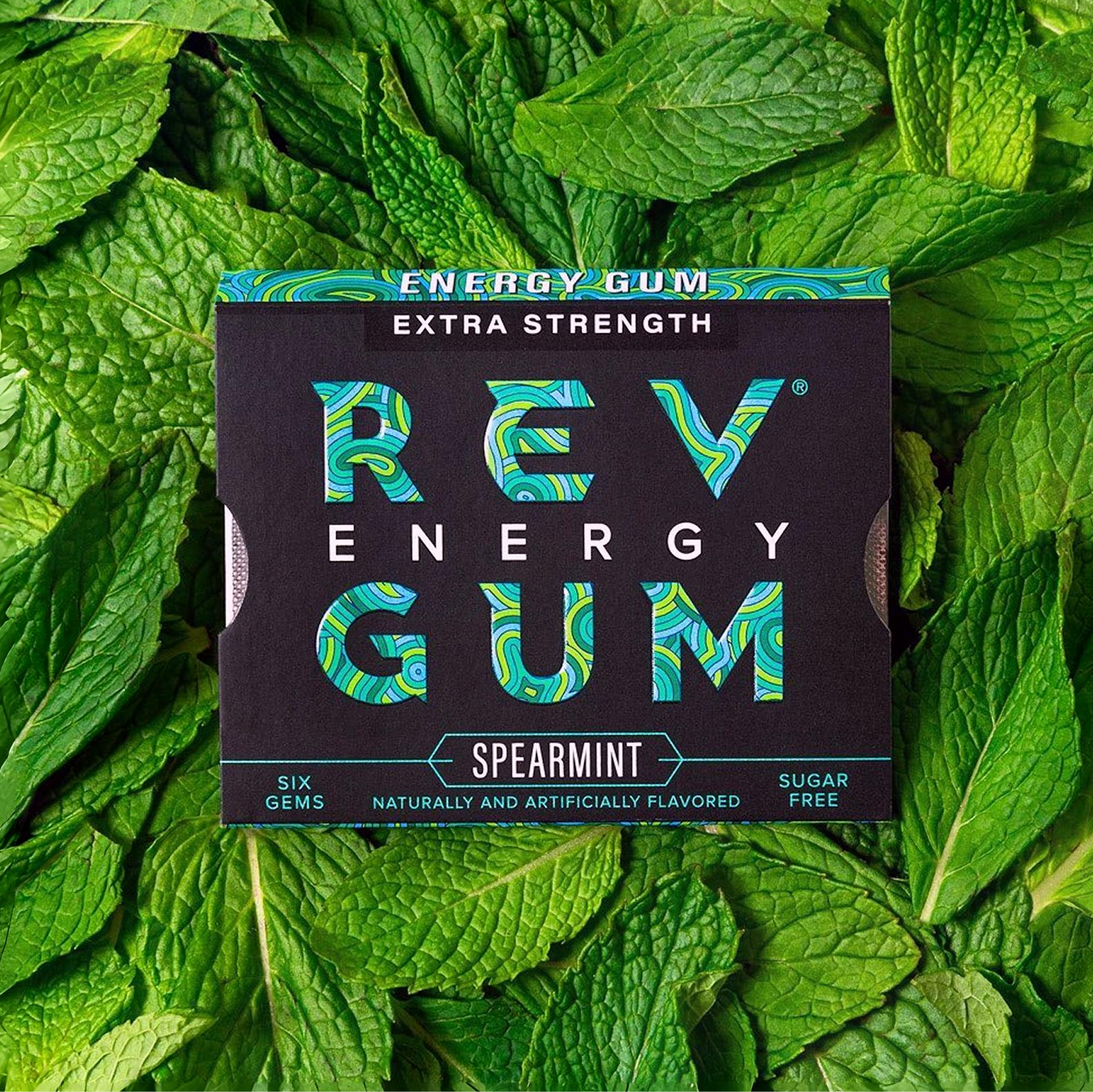 REV Energy Gum packaging on a bed of mint leaves